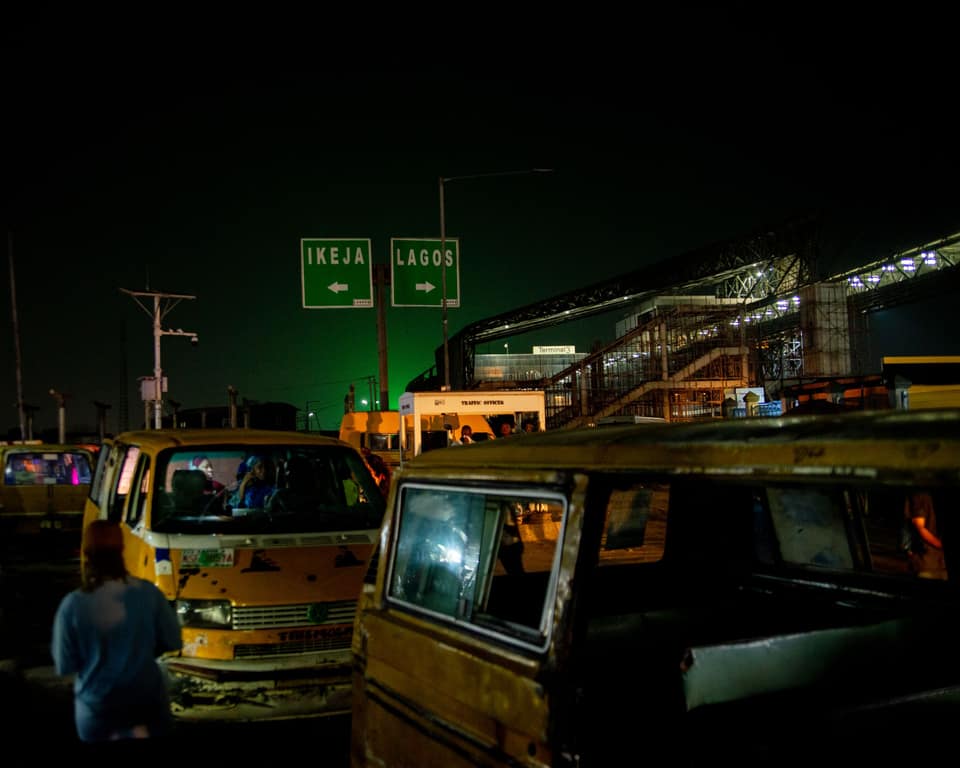 Danfos under green gantry signs at night